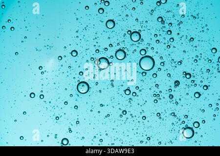 Close-up of blue translucent gel with bubbles, creating an abstract texture. The image highlights the beauty of cosmetic formulations and natural flui Stock Photo