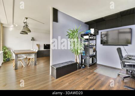A contemporary home office featuring sleek furniture and a touch of greenery, highlighting an inviting workspace atmosphere for productivity. Stock Photo