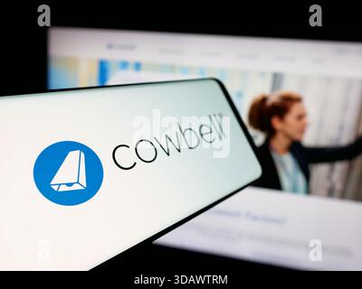 Stuttgart, Germany - 11-30-2025: Smartphone with logo of US insurance company Cowbell Cyber Inc. on screen in front of website. Stock Photo