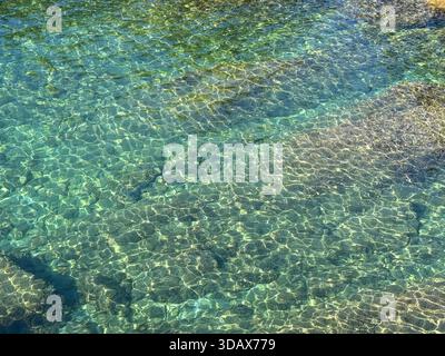 Beautiful sea water clear turquoise seascape with underwater stones and pebbles Stock Photo