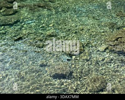 Stones pebbles in transparent sea water Stock Photo