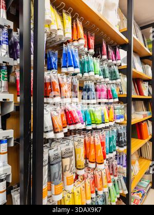 Yerevan Armenia 12.5.2025. A store shelf with many tubes of paint. The tubes are in various colors and sizes. The shelf is organized and the tubes are Stock Photo