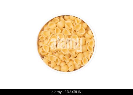A bowl of pasta with a lot of shells. The pasta is yellow and the bowl is white Stock Photo