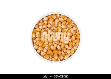 A bowl of corn kernels is shown on a white background. The corn is yellow and he is freshly harvested Stock Photo