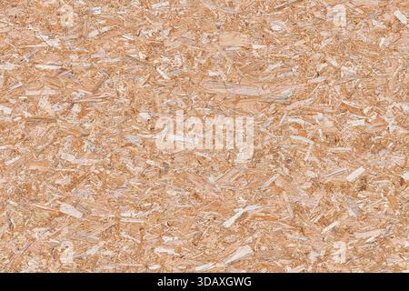 High-resolution background texture of an OSB, Oriented Strand Board, panel. The surface displays a seamless pattern of natural light brown and tan pre Stock Photo