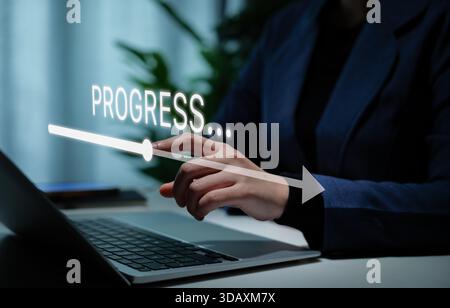 Progress concept. Businesswoman using laptop with glowing progress bar and arrow symbolizing digital transformation, business growth, strategy Stock Photo