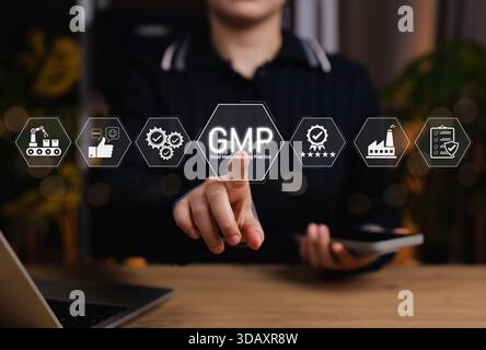 Concept of Good Manufacturing Practice (GMP) in modern industry. Person touching GMP certified icons related to quality control, production standards, Stock Photo
