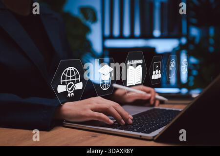 Online education and e-learning technology concept. Person using laptop with icons of graduation, digital certificate, learning innovation for global Stock Photo