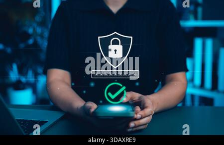 Cybersecurity and Data Protection Concept. Person holding smartphone with digital icons of lock, password entry, and verification checkmark, Stock Photo