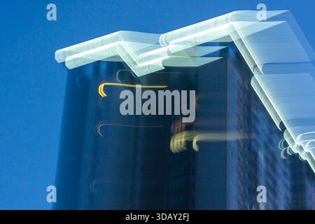 Abstract motion blur of a modern blue glass skyscraper. Corporate business and finance background texture. Stock Photo