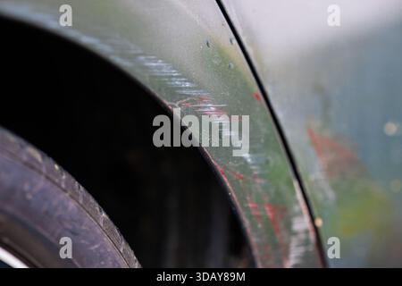 Scuff marks on the wheel arch of a grey hire car Stock Photo