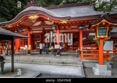 Pilgrims and worshippers in front of Kumano Nachi Taisha. It is one of the three great shrines (Kumano Sanzan) in the Kumano region and a central pilgrimage site on the Kumano Kodo trail. Visitors praying in front of Kumano Nachi Grand Shrine in Nachikatsuura, Wakayama Prefecture, Japan Stock Photo