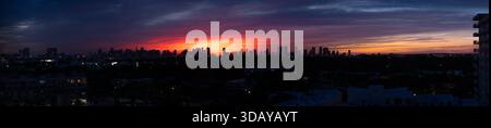 EXtra wide panoramic view of the skyline of downtown Miami before a vivid colorful dark sunset Stock Photo