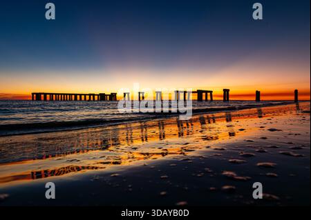 Colorful sunset over the old pier of Fort Myers's beach, Florida Stock Photo
