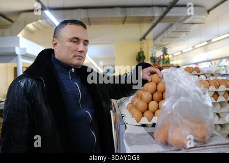Man holding egg box in supermarket. egg box buy carton man hold checking consumer concept. High quality photo Stock Photo