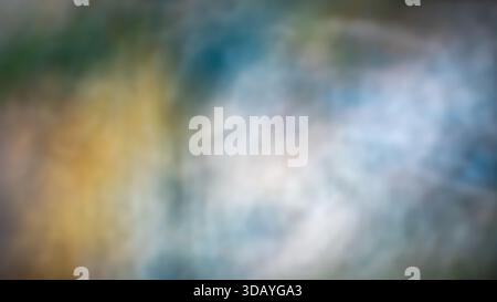 Soft abstract blurred background with smooth defocused transitions in blue, green, yellow, and light gray tones. Gentle color flow creates a calm Stock Photo