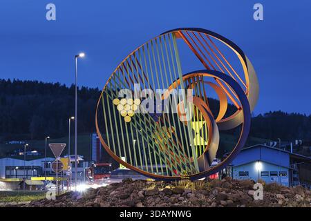 Long exposure, art sculpture in traffic roundabout, Toessallmend roundabout, gateway to Zurich wine country, colorful steel sculpture illuminated at d Stock Photo