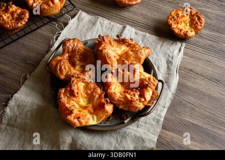 Yorkshire puddings on plate on wooden table. Close up view Stock Photo