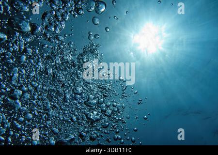 Bubbles and sunlight underwater. Blue abstract background. Stock Photo
