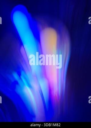 Soft neon hues blend into fluid glowing waves across luminous gradients. Neon glowing blur background. Stock Photo