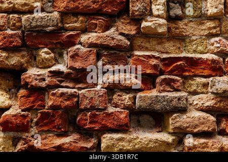 Texture of ancient weathered red and brown brick wall. Stock Photo