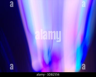 Soft neon hues blend into fluid glowing waves across luminous gradients. Neon glowing blur background. Stock Photo