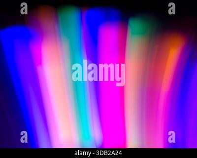 Vibrant colorful neon light streaks in blue pink and violet purple tones creating dynamic motion and gradient glow Stock Photo