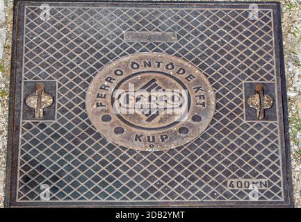Balatonfured, Hungary. Manhole covers in Balatonfured, Hungary. Manufactured by Ferro Ontode Kft., a foundry located in Kupa, Hungary. Stock Photo