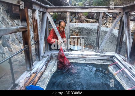 People in Yunomine Onsen have been using the hot springs for cooking since at least the Edo period (1603 to 1868). Today, tourists can buy eggs and vegetables in a mesh bag to cook them in the 90 °C water. Tanabe, Wakayama Prefecture, Japan Stock Photo