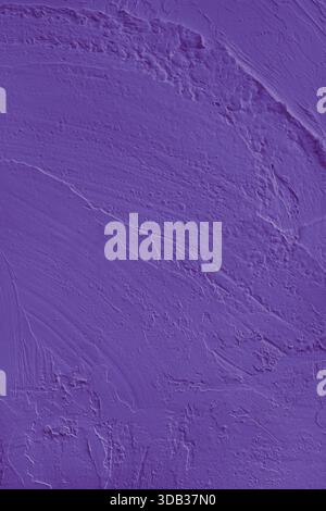 Close up, macro of vibrant purple colored cement wall surface with rough, heavily textured, and abstract plaster strokes. Grunge background, industria Stock Photo