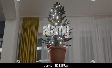 Christmas tree with lights on in the living room Stock Photo