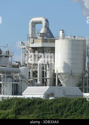 RHINE RIVER, GERMANY - MAY 26, 2025 - Industrial complex on the Rhine River featuring large silos, pipes, and structures, symbolizing energy productio Stock Photo