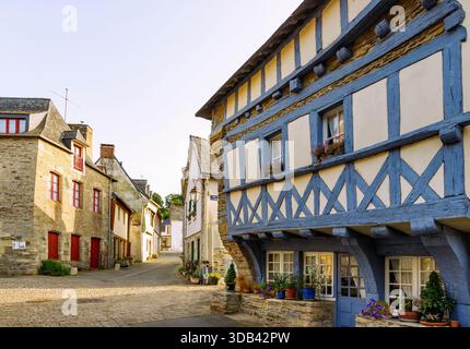 Sainte-Croix quarter with half-timbered houses and granite stone houses in the old town of Josselin, Morbihan, Brittany, France Stock Photo