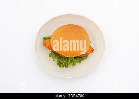 fish hamburger with tartar sauce on plate isolated on white background Stock Photo