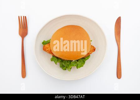 fish hamburger with tartar sauce on plate isolated on white background Stock Photo