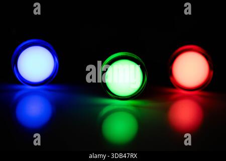 Blue Green and Red LED Indicator Lights Aligned on Dark Background Stock Photo