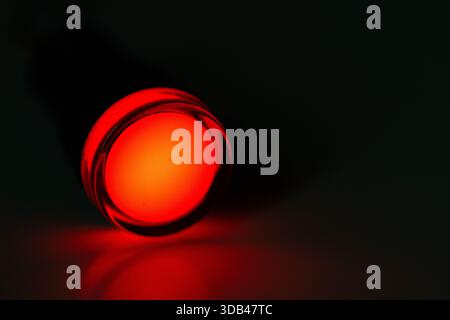 Red LED Indicator Light Isolated on Dark Background Stock Photo