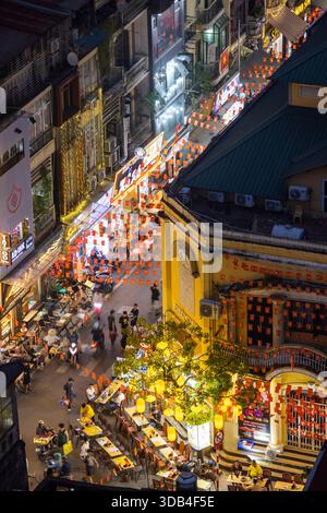 View from the rooftop bar of the Skyline Lounge at the Hanoi Tirant Hotel overlooking the bustling streets of Hanoi's Old Quarter at dusk, Hanoi, Stock Photo