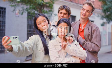 Diverse friends taking inclusive street selfie together Stock Photo