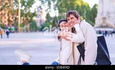 Happy diverse couple embracing outdoors Stock Photo
