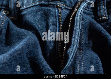 A closeup view of a zipper on a pair of jeans. Stock Photo