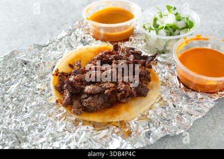A view of an al pastor street taco. Stock Photo
