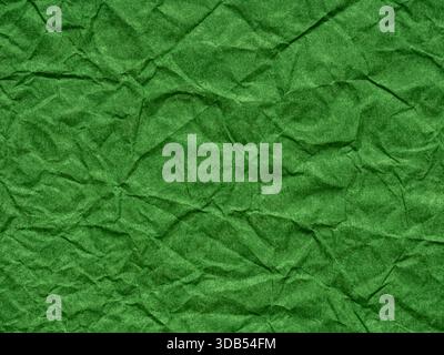 Dark green crumpled paper texture. Background for handcrafts, Saint Patrick's Day, new year designs decoration, text, lettering, wall screen saver Stock Photo