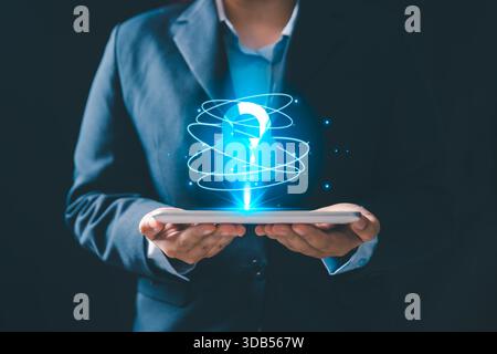 A business professional holding digital tablet with a glowing holographic padlock icon, representing cybersecurity, data protection, privacy, secure t Stock Photo