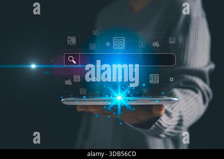Person holding a tablet with a glowing virtual search bar and digital interface icons, representing online technology, smart data searching, futuristi Stock Photo