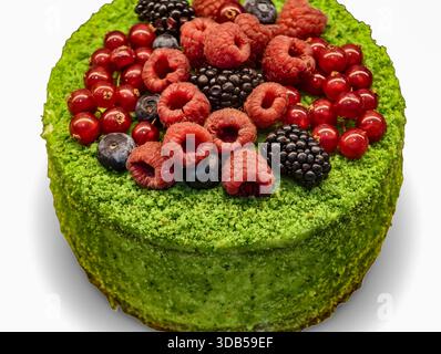 Green crumb-coated cake topped with fresh berries for gourmet and healthy dessert themes. Sweets Background Stock Photo