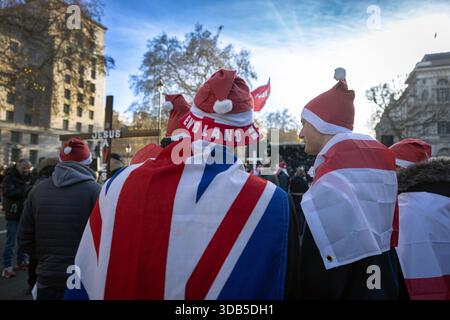 London, England, United Kingdom. 13th Dec, 2025. Protesters take part in the 'Unite The Kingdom' demonstration on Whitehall, organised by far-right activist Tommy Robinson (real name Stephen Yaxley-Lennon). The event was framed as a Christmas carol service aimed at promoting Christian religion and British values during the festive season. The gathering, which drew an estimated 1,000 attendees, was met with a significant police presence and a nearby counter-protest. Credit: horst friedrichs/Ģ����ý Live News Stock Photo