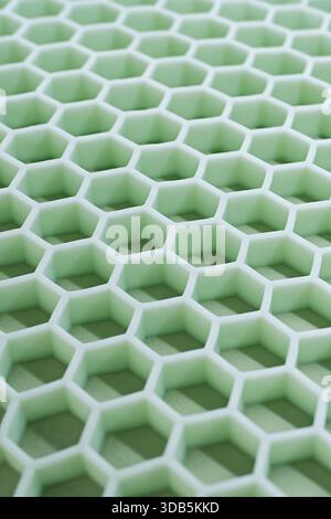 Hexagonal cells of honeycomb filler for orthopedic mattresses, close-up shot, abstract geometric background Stock Photo