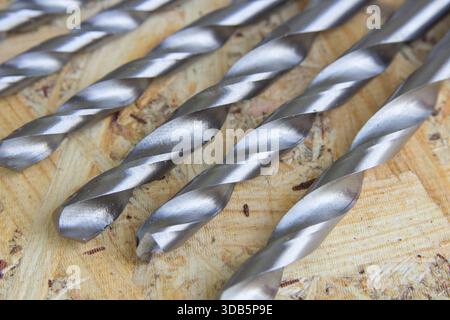 new metal drills set for metal lie on wooden background Stock Photo