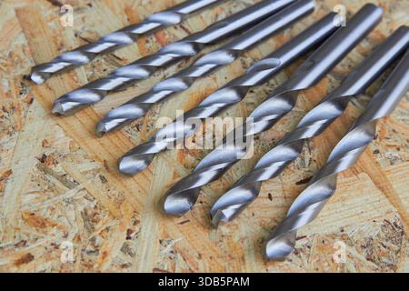 set of drills on metal on wooden background Stock Photo